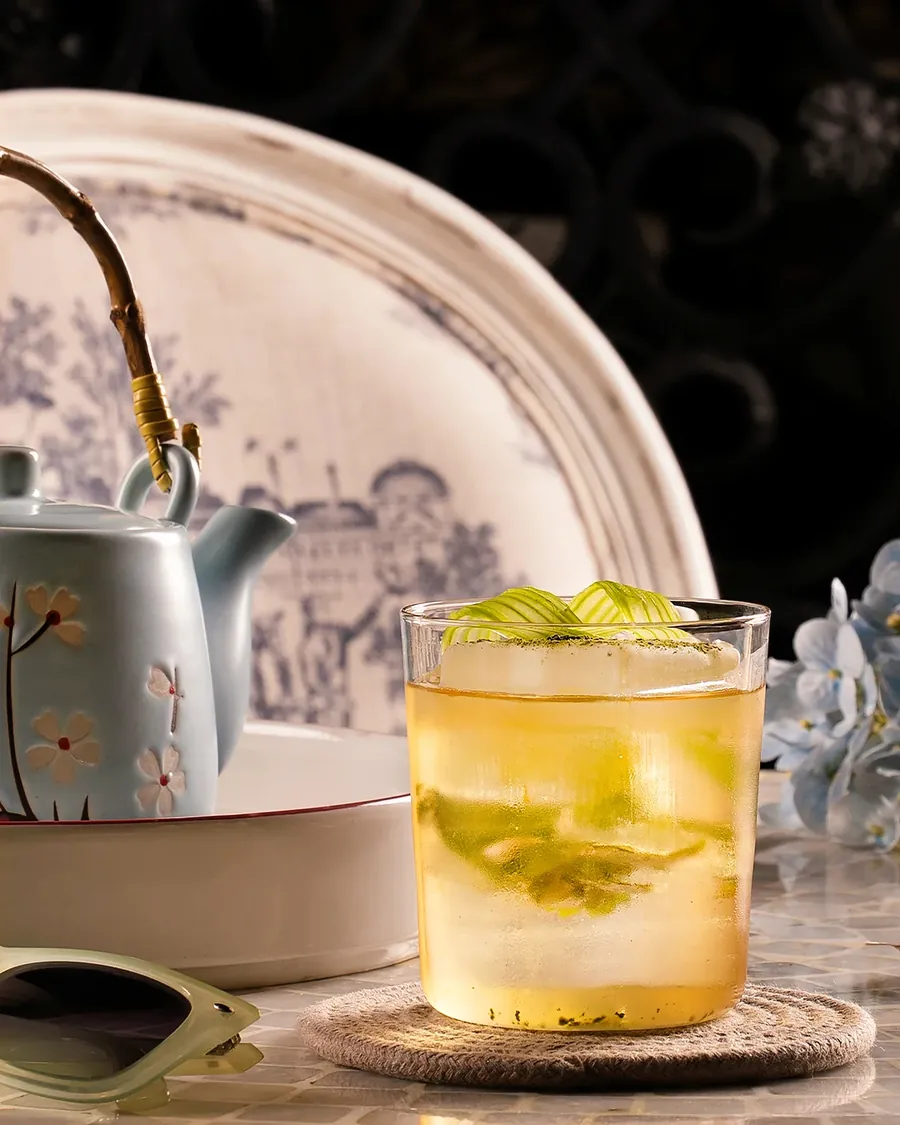 Lemon iced tea poured from a porcelain teapot