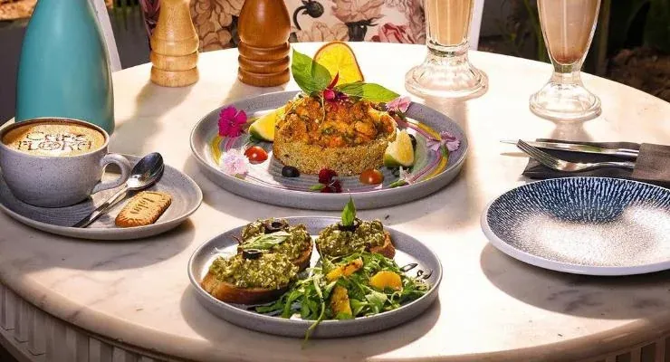 A table laid with brunch plates, coffee and flowers